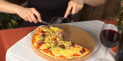 10547695-mujer-de-comer-pizza-vegetariana-en-una-pizzeria